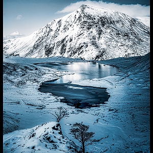 Winter reflections on Llyn Idwal with Pen yr Ole Wen in the background