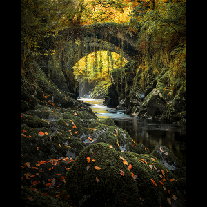 Autumn colours at the Roman Bridge in Penmachno in the Eryri / Snowdonia National Park, Wales.