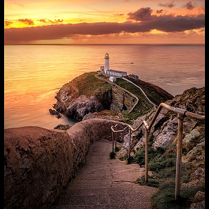 South Stack Lighthouse with a warm sunset in the background
